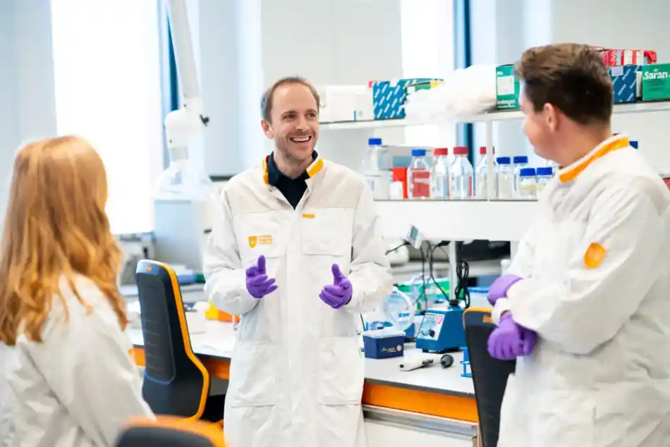 Three researchers talking in the laboratory